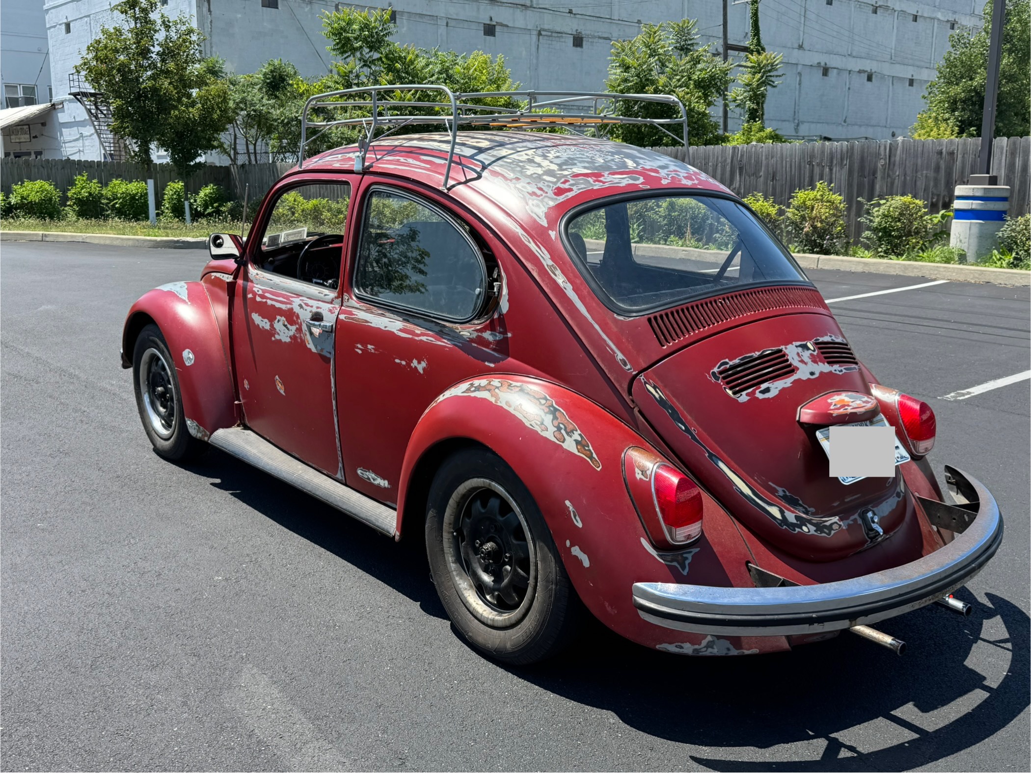 Rear three-quarter view with roof rack and patina finish
